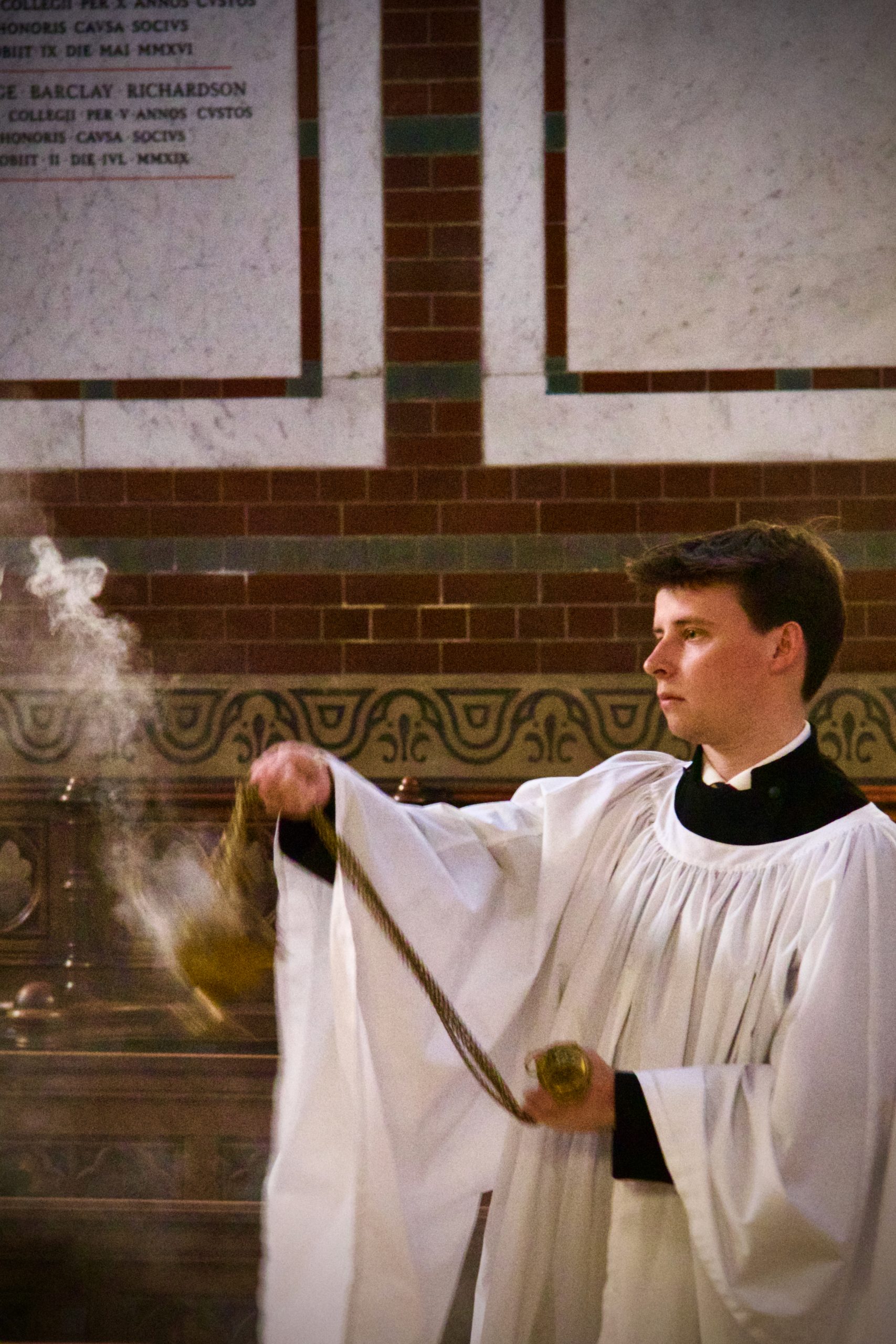 Thurifer censing congregation